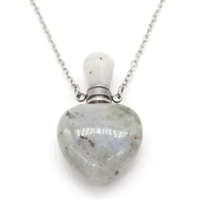 Close-up of heart-shaped natural grey stone perfume bottle necklace with silver chain