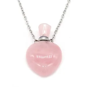 Detailed view of pink quartz heart-shaped perfume bottle pendant with silver chain