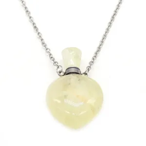 Macro shot of a heart-shaped yellow natural stone essential oil bottle pendant