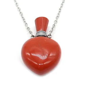 Heart-shaped red jasper perfume bottle necklace with silver metal chain on white background