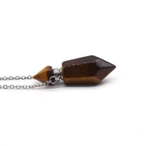Macro detail of hexagonal tiger eye stone prism pendant with silver metallic connector