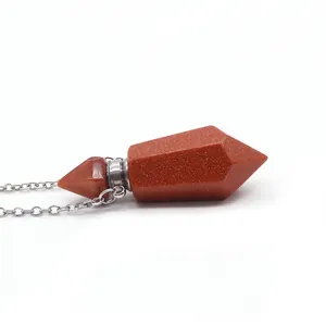 Macro view of gold sandstone hexagonal perfume bottle necklace with silver screw cap