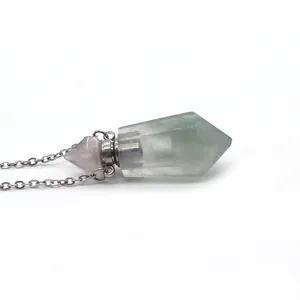 Macro shot of translucent green natural stone perfume bottle pendant with silver chain