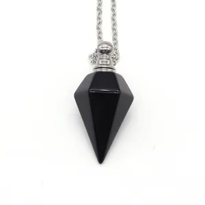 Macro shot of a black obsidian hexagonal perfume bottle pendant with silver metal cap