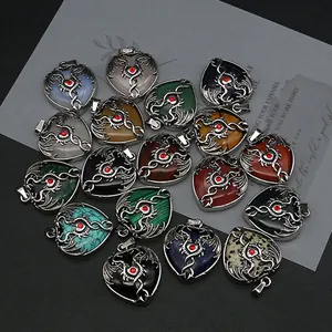 Gothic dragon wrapped heart pendants set in various natural stones with red gemstone accents