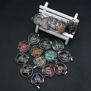 Natural gemstone heart pendants with silver dragon wrap on a black leather background