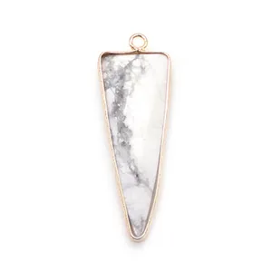 Macro detail of elongated triangle white marble stone pendant with rose gold plated frame