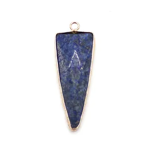 Macro shot of triangular lapis lazuli pendant with gold plating and V-shaped engraving