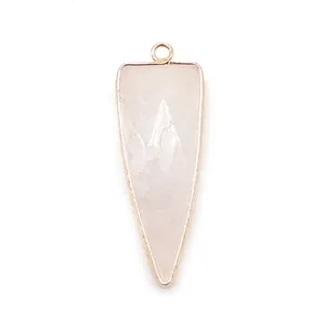 Detailed macro view of the triangular rose quartz pendant with a polished gold plating edge
