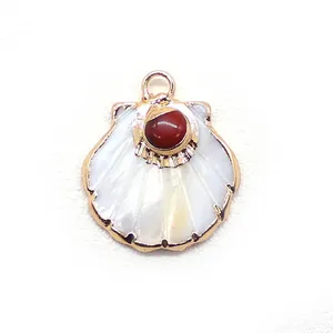 Detail of scallop shell pendant with white mother of pearl and red stone inlay