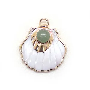 Detail of scallop shell pendant with green stone inlay and gold-plated finish