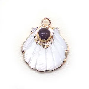 Macro detail of fan-shaped white mother of pearl pendant with gold plating and purple gemstone