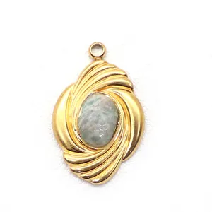 Macro detail of gold geometric swirl pendant featuring an oval light green natural stone
