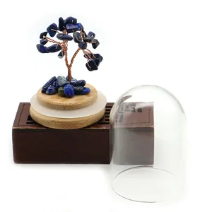 Detailed shot of a lapis lazuli crystal tree with glass dome on a bamboo base