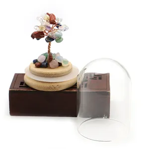 Detailed view of handmade crystal tree with glass dome and natural gemstone leaves