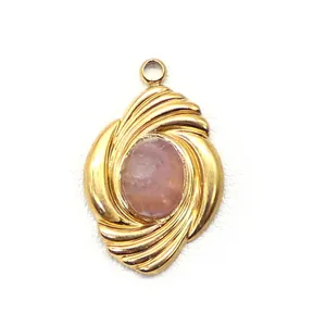Macro detail of a gold spiral pendant featuring an oval purple natural stone inlay
