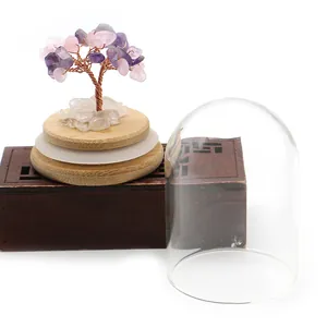 Detail of amethyst crystal tree with copper wire trunk and protective glass dome