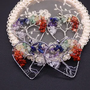 Handmade Tree of Life heart pendants with natural crystal stones on a lace background