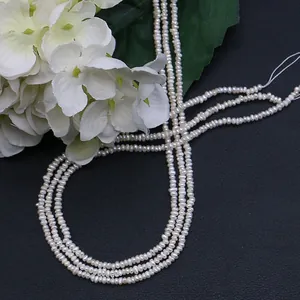 Strand of white irregular freshwater pearls for DIY jewelry making on dark leather