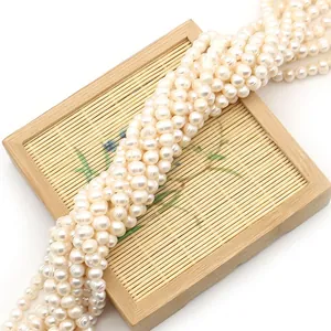 Natural freshwater white potato pearls on bamboo tray for DIY jewelry making