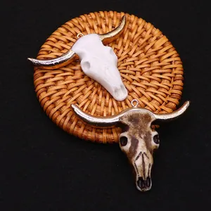 Tribal bull skull pendants with gold horns in white and textured bone resin finishes