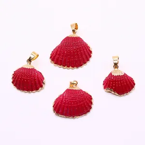 Close-up of four red shell pendants with gold plated edges for DIY jewelry making