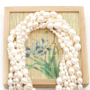 Lustrous white freshwater baroque pearls on rustic bamboo mat for jewelry making