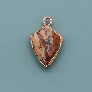 Detailed view of natural spotted stone shield pendant with rose gold plated metal edge