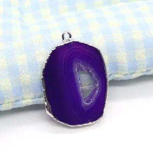 Detailed view of a purple natural agate geode pendant with silver-plated metal frame