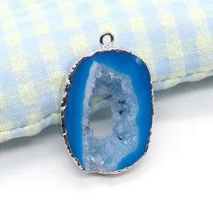 Macro shot of oval blue natural agate druzy pendant with silver plated edge and bail