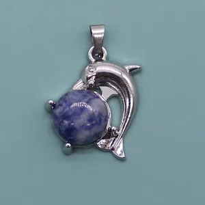 Detailed view of dolphin-shaped pendant with purple marble stone and silver metal