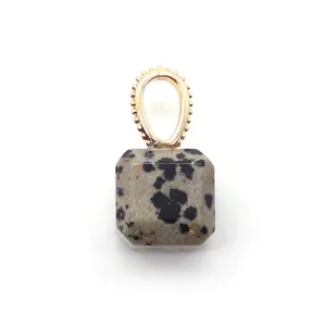 Detail of Dalmatian Jasper square pendant with decorative gold plated bail and spots