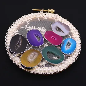 Set of seven irregular natural agate geode pendants in vibrant colors with silver plating