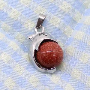Macro detail of S925 silver dolphin pendant featuring a shimmering goldstone round bead