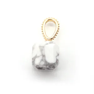 Detailed view of faceted white howlite square stone pendant with gold beaded metal clip