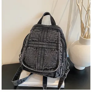 Macro shot of washed denim fabric texture and sturdy zipper on vintage gray backpack