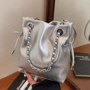 Fashionable silver metallic drawstring bucket bag with thick chain handle and strap
