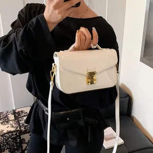 Elegant white patent leather handbag with gold square lock and detachable shoulder strap