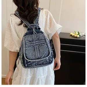 Model view of large-capacity washed denim backpack in retro blue with adjustable straps