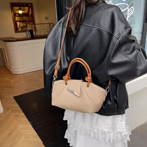 Detail of vintage pleated bucket bag with lychee texture leather and leaf clasp