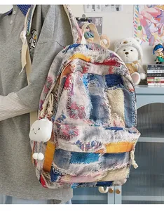Detail of woven gradient mini backpack with soft cloud charm in cozy room setting