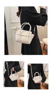 Detailed view of a chic cream leather handbag with adjustable strap and textured finish