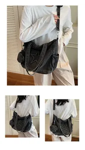 Macro detail of black denim star tote bag with detachable round coin purse and strap