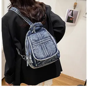 Macro detail of washed denim blue backpack featuring retro texture and stitching