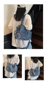 Detail view of denim tote bag featuring star patch design and mini round pendant pouch