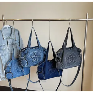 Detail of denim tote bags in four shades featuring star patches and mini round pouches