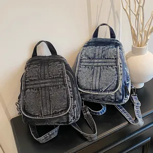 Retro washed denim backpacks in dark grey and blue with cross stitching and side pockets