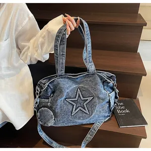 Detail of blue denim tote bag with star design and detachable mini round coin pouch
