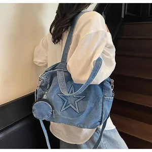 Blue denim tote bag featuring star quilting and a small round coin pouch attachment