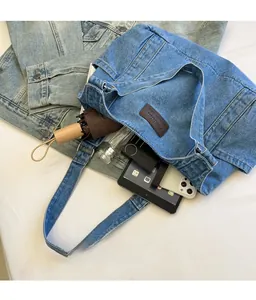 Detailed internal capacity of denim tote bag showing tablet, umbrella, and daily essentials